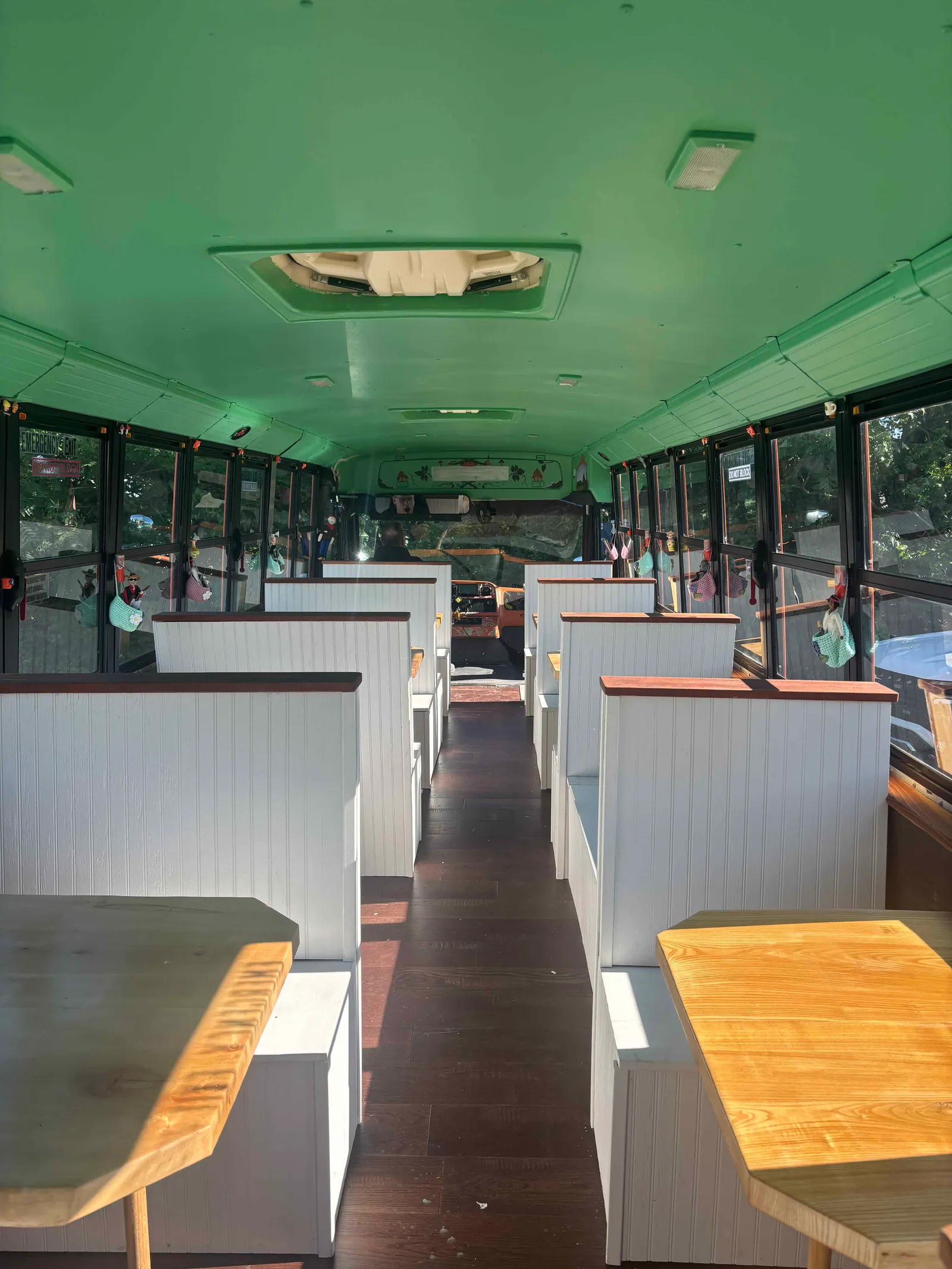 Inside the bus, white church-pew booths and dark hardwood floors down the aisle